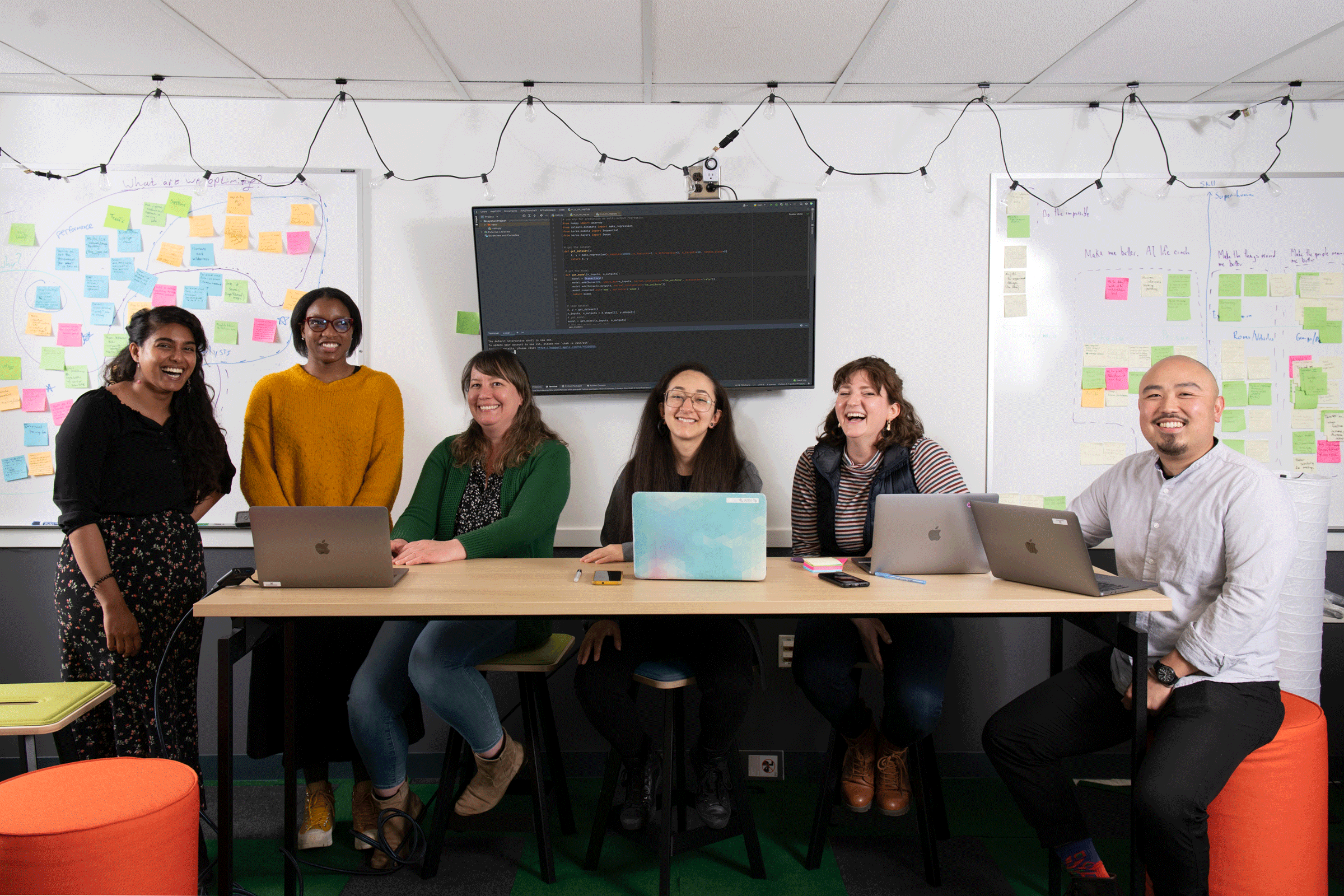 Draper team smiling together at a table