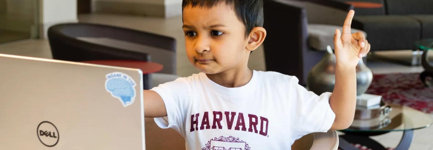 child at laptop Ω