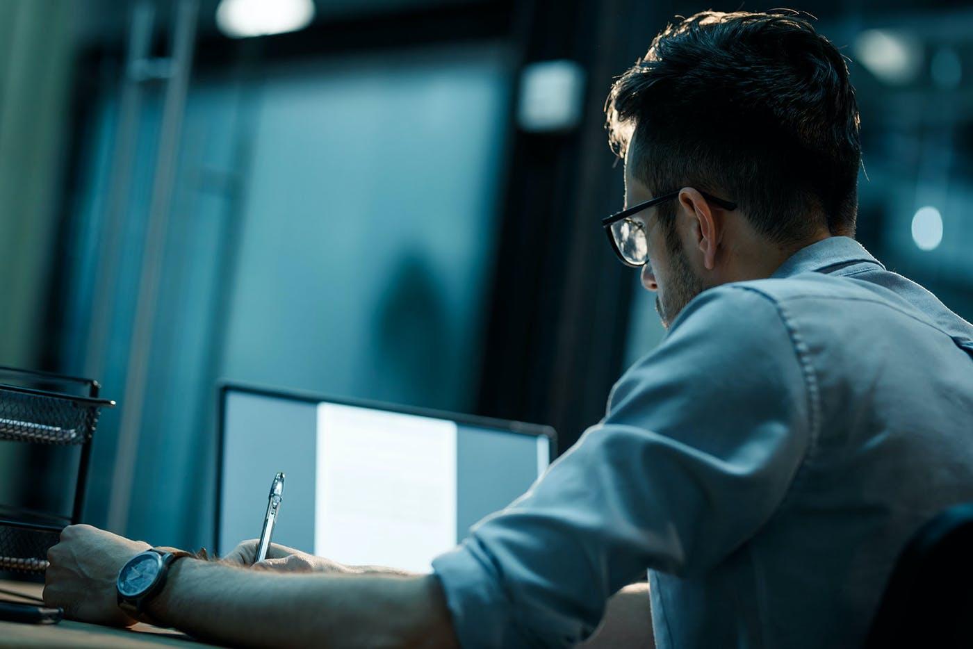 Man sitting at a desk looking at the computer screen - header image for SEO Recommendations for Expanding in China blog