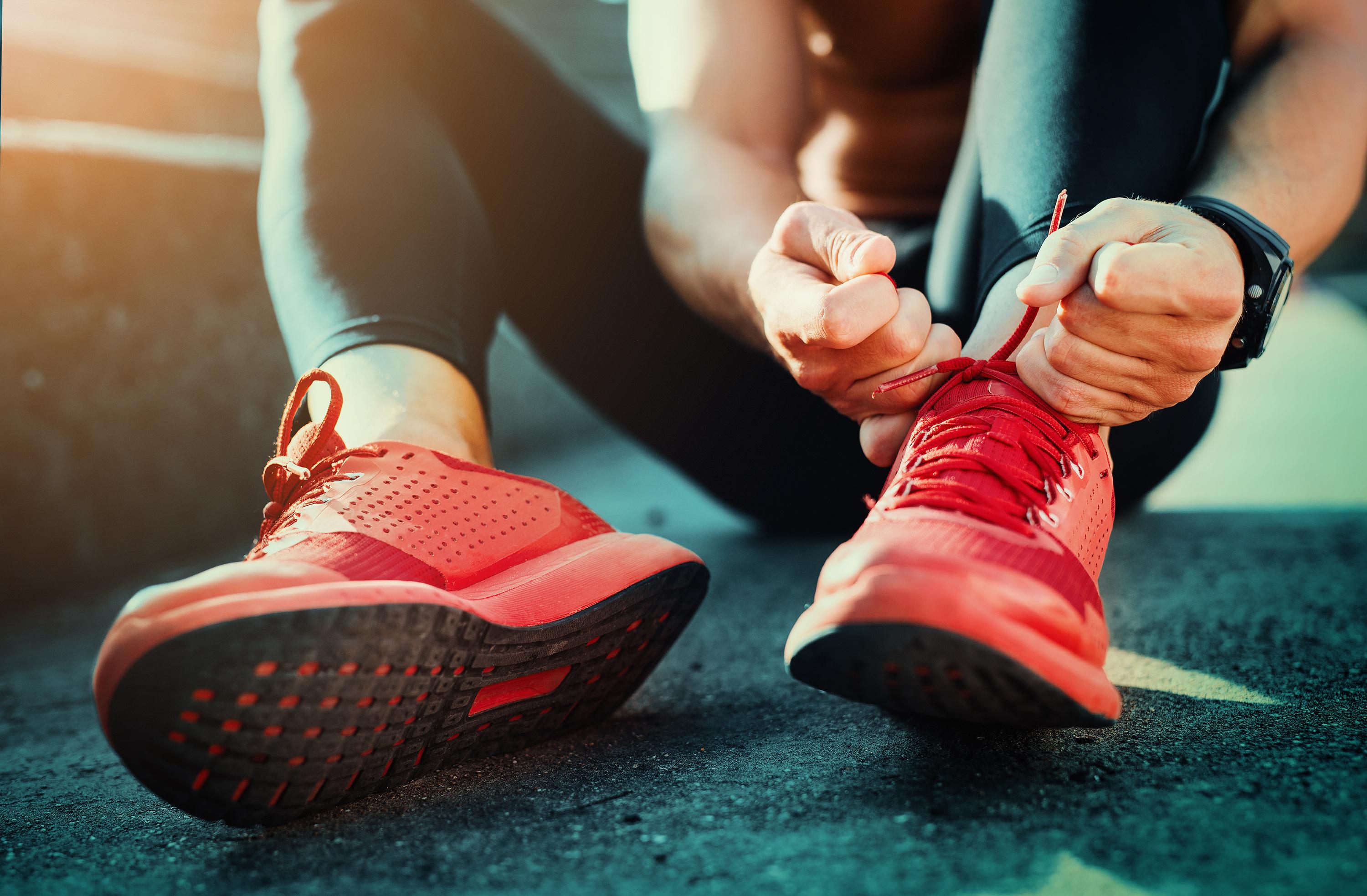 Person tying shoes symbolizing the article Setting Up Your Google Analytics Account for Success