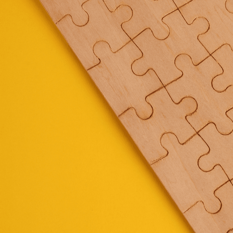 wood puzzle on a yellow background 
