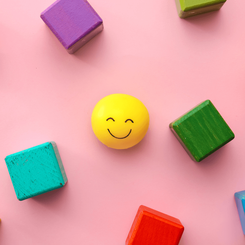 colorful square blocks with a smiley face in the center