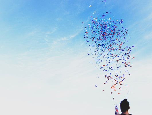 exploding confetti shoots up into the sky 