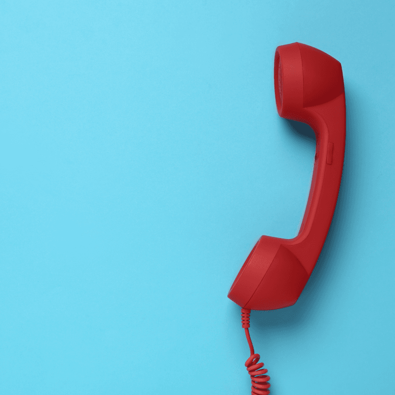red phone against a blue background 